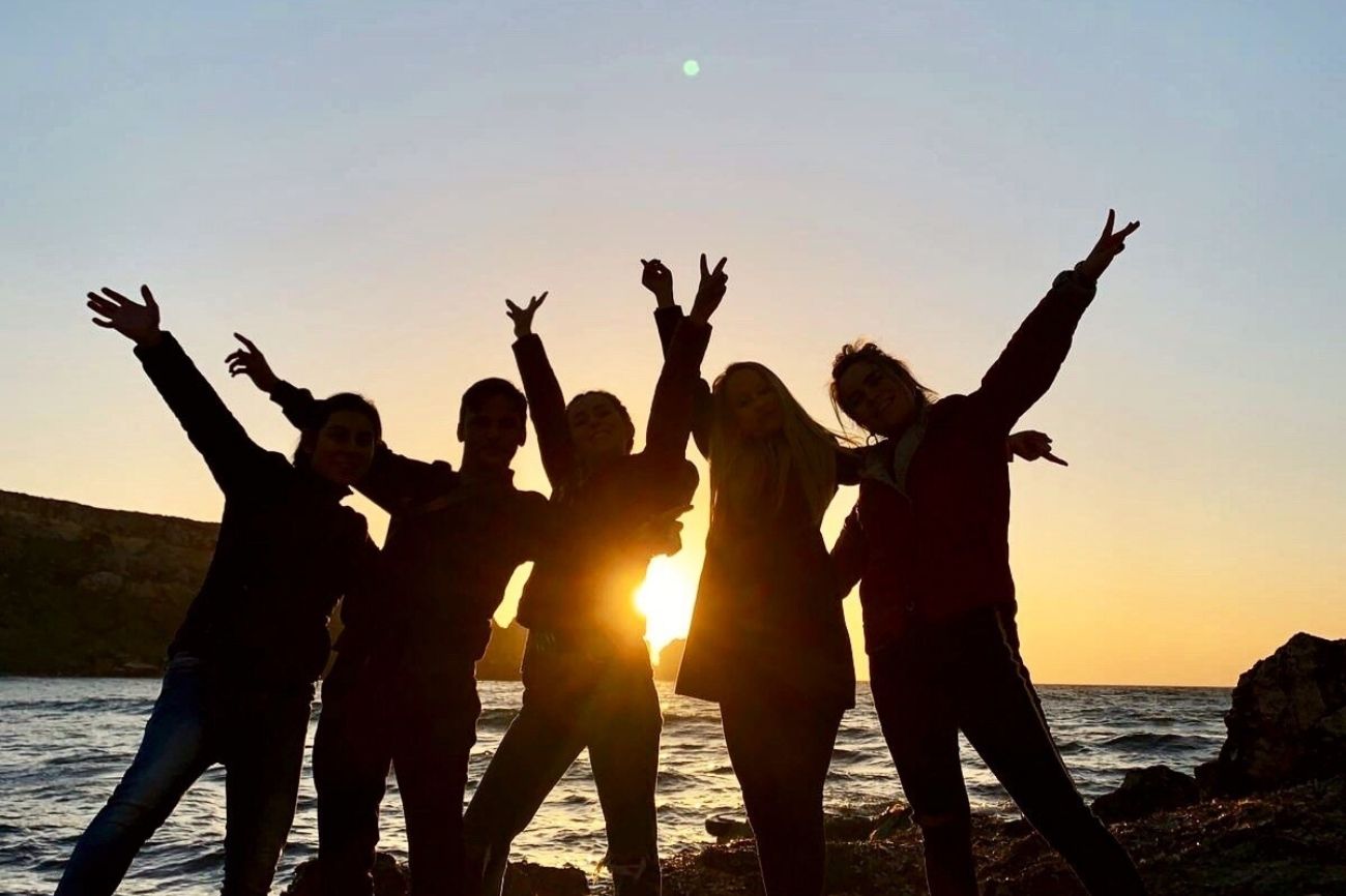 A group of our students with the sunset